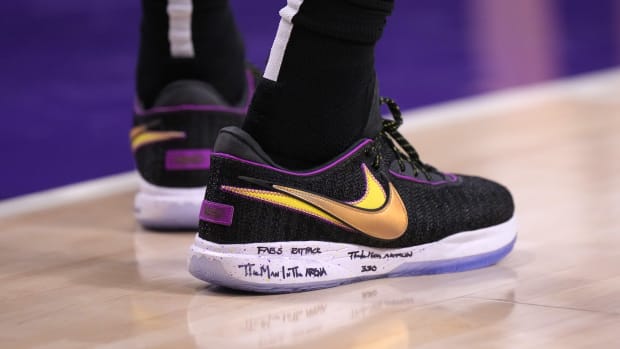 View of black and gold Nike LeBron shoes.